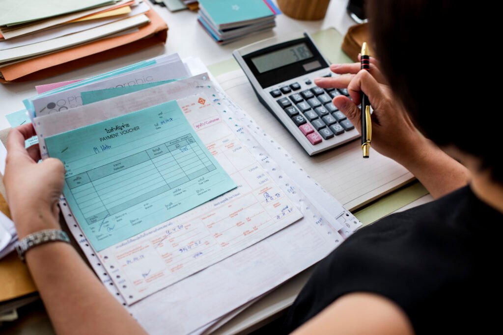 Asian Woman Working Through Paperwork